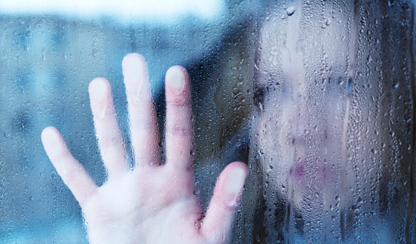 woman looking through rainiy window.jpg